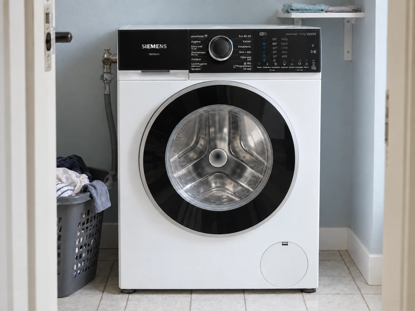 Siemens WG56H205NL in een bijkeuken met een wasmand naast de machine